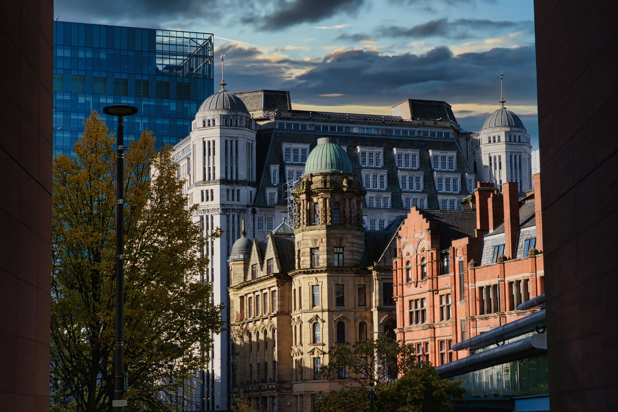 Urban Skyline with Glass, White, and Red-Brick Buildings in Manchester, UK.